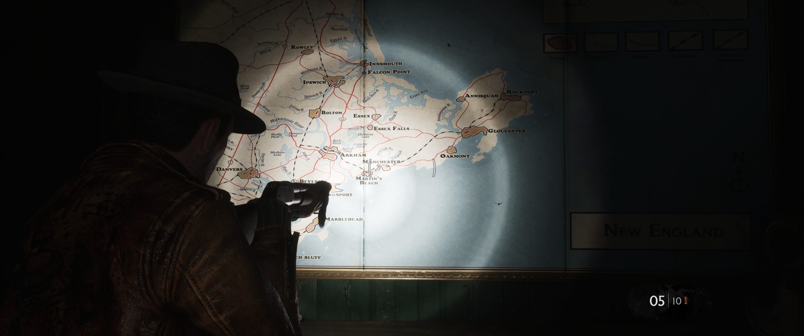 Character examining a regional map of New England